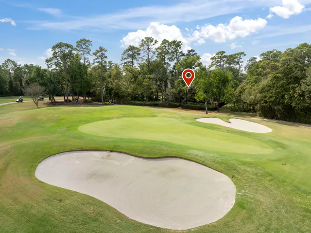 an aerial view of a house with swimming pool and garden