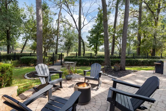 a view of a patio with couches chairs and a fire pit