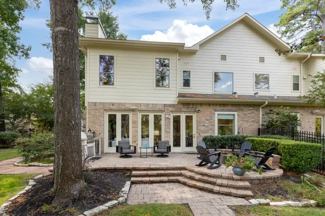 a view of a house with backyard porch and sitting area
