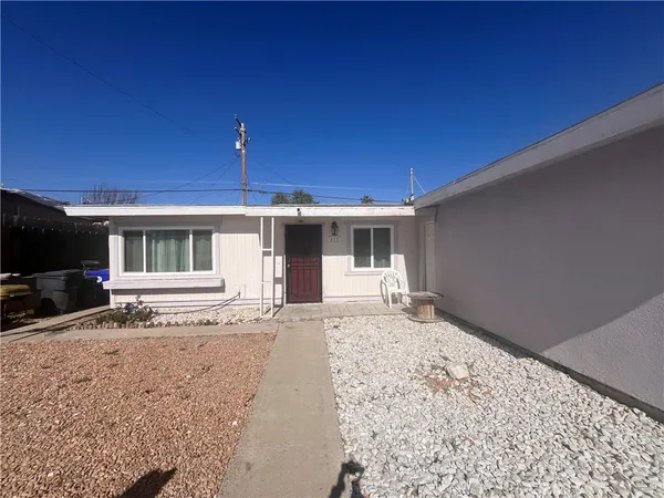 a front view of a house with a yard in front of it