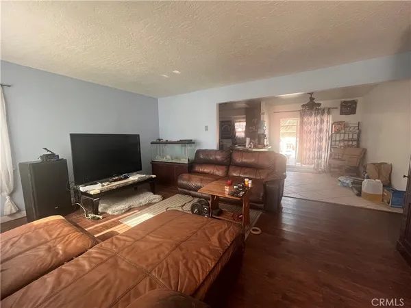 a bedroom with furniture and a flat screen tv