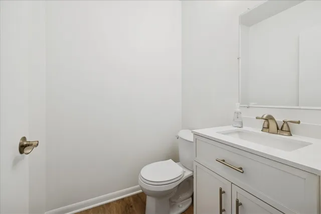 a bathroom with a sink toilet and a mirror