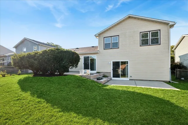 a view of a house with a yard and a garden