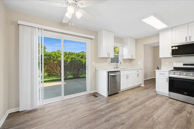 a kitchen with a stove a sink and a microwave
