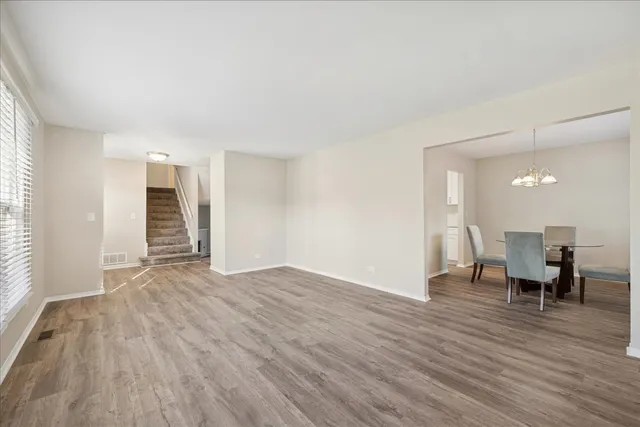an empty room with wooden floor and furniture
