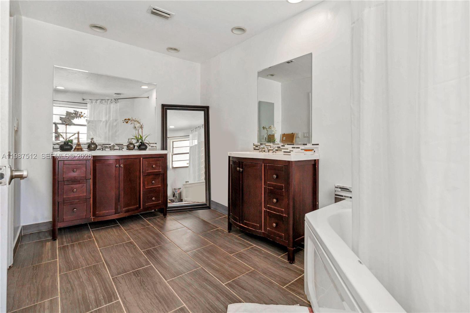 14461 Southwest 285th Street Homestead, FL 33033 - Photo 14 of 17 a spacious bathroom with a tub sink and mirror