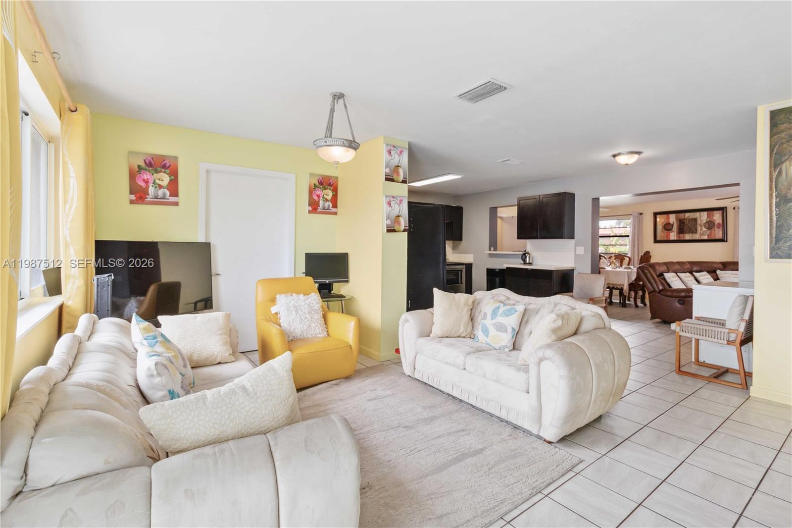 14461 Southwest 285th Street Homestead, FL 33033 - Photo 3 of 17 a living room with furniture fireplace and a flat screen tv