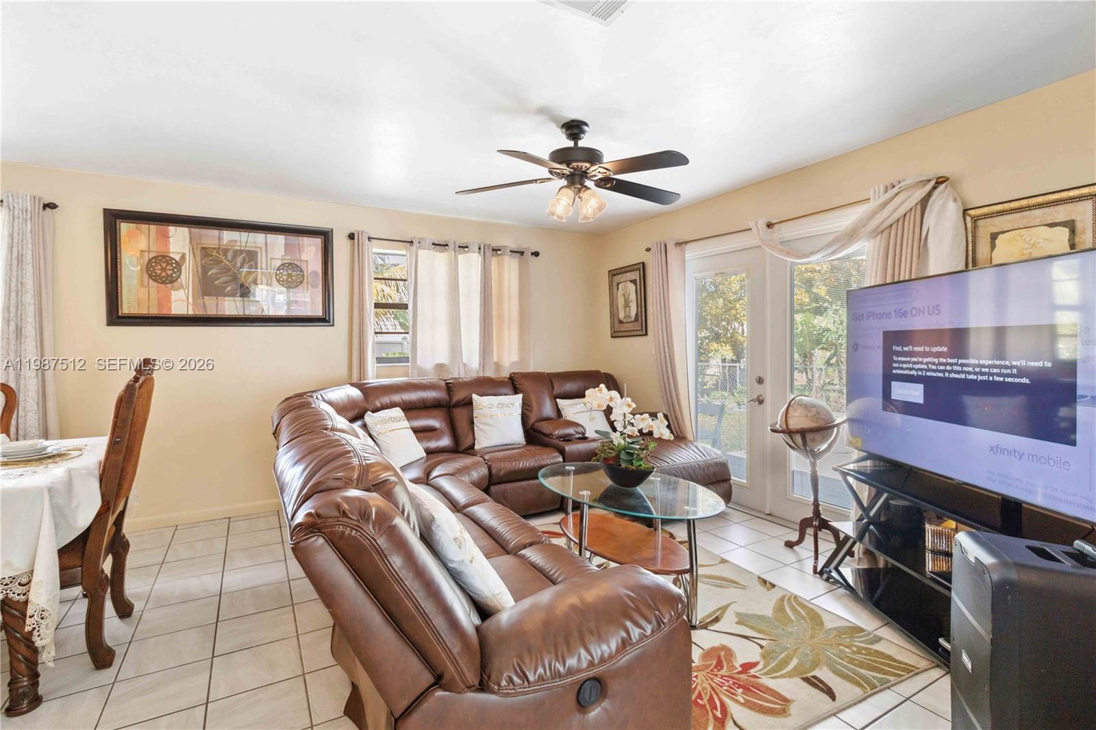 14461 Southwest 285th Street Homestead, FL 33033 - Photo 6 of 17 a living room with furniture a fireplace and a flat screen tv