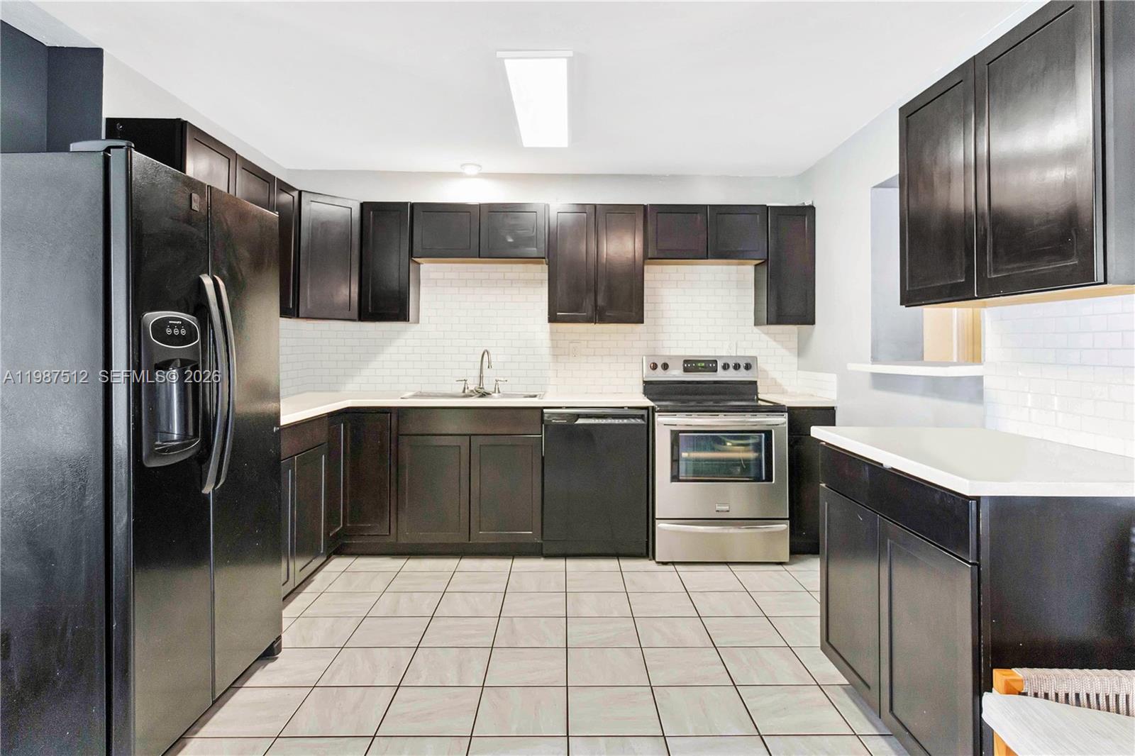 14461 Southwest 285th Street Homestead, FL 33033 - Photo 9 of 17 a kitchen with granite countertop a refrigerator and a stove