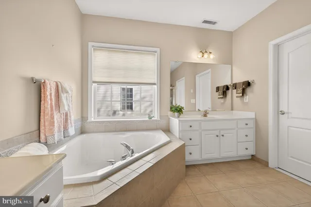 a bathroom with a sink toilet and mirror