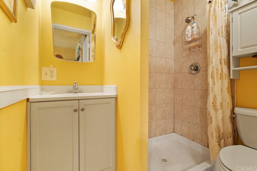 18777 Walnut Road Castro Valley, CA 94546 - Photo 28 of 68 a bathroom with a sink mirror toilet and shower