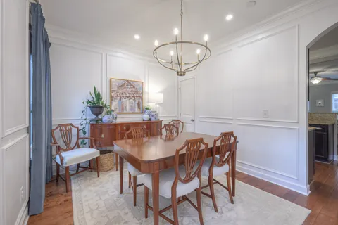 a view of a dining room with furniture wooden floor and chandelier