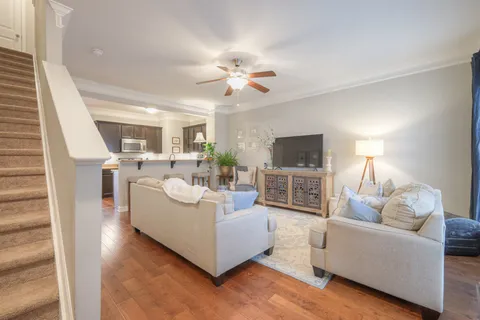 a living room with furniture a flat screen tv and a fireplace