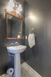 a bathroom with a sink toilet and mirror