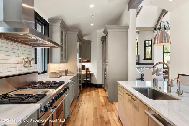 a view of a dining room with furniture a chandelier and wooden floor