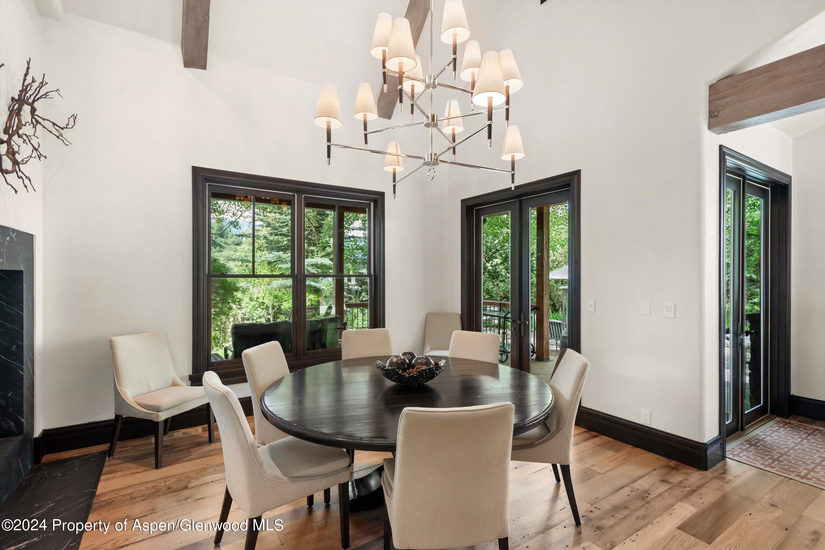 27 Nighthawk Drive Aspen, CO 81611 - Photo 15 of 61 a view of a dining room with furniture a chandelier and wooden floor