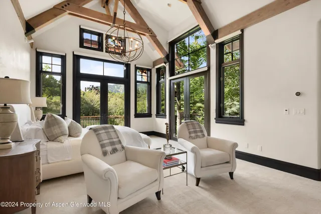 a bed sitting in a bedroom next to a large window