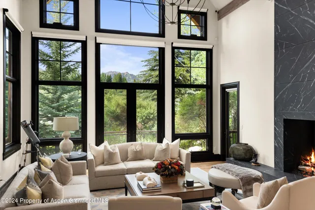 a living room with furniture tv and a large window