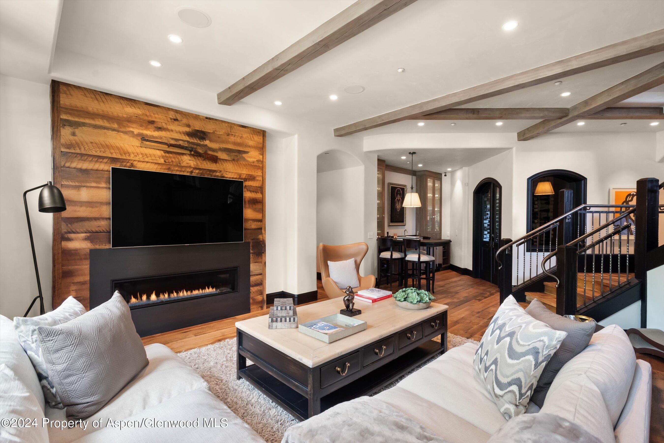 27 Nighthawk Drive Aspen, CO 81611 - Photo 27 of 61 a living room with furniture a flat screen tv and a fireplace