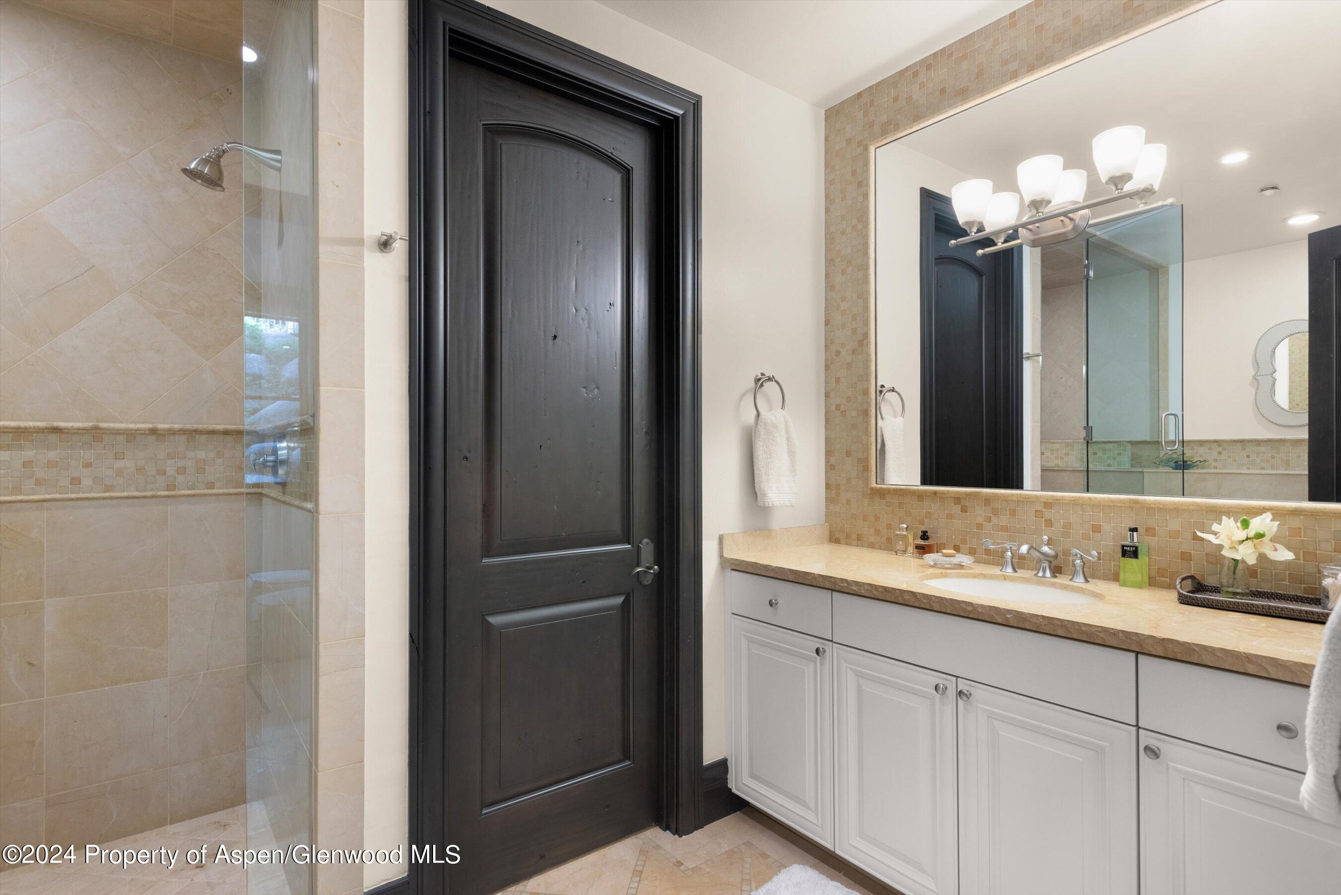 27 Nighthawk Drive Aspen, CO 81611 - Photo 35 of 61 a bathroom with a double vanity sink and a mirror