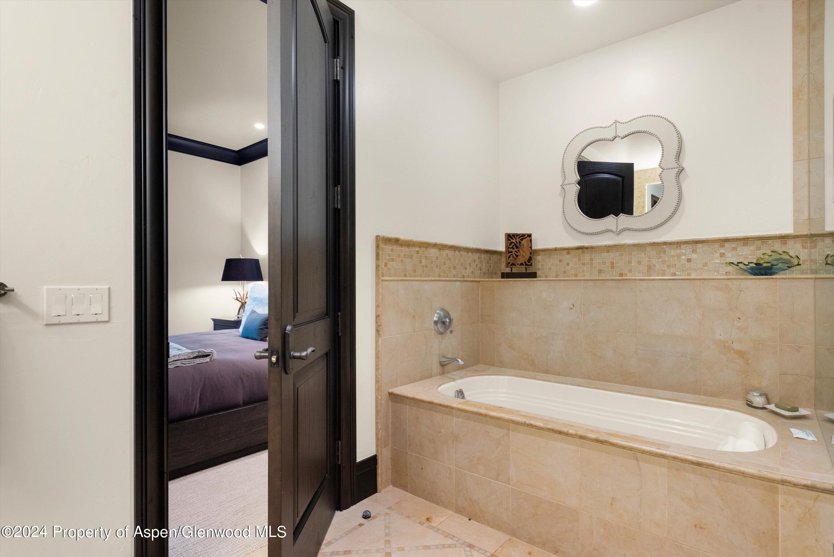 27 Nighthawk Drive Aspen, CO 81611 - Photo 36 of 61 a bathroom with a tub sink and mirror