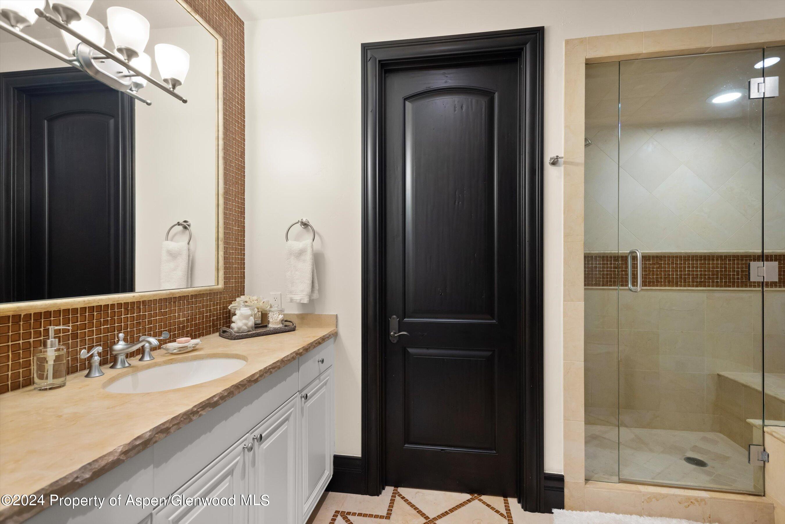 27 Nighthawk Drive Aspen, CO 81611 - Photo 38 of 61 a bathroom with a sink vanity granite shower and a mirror