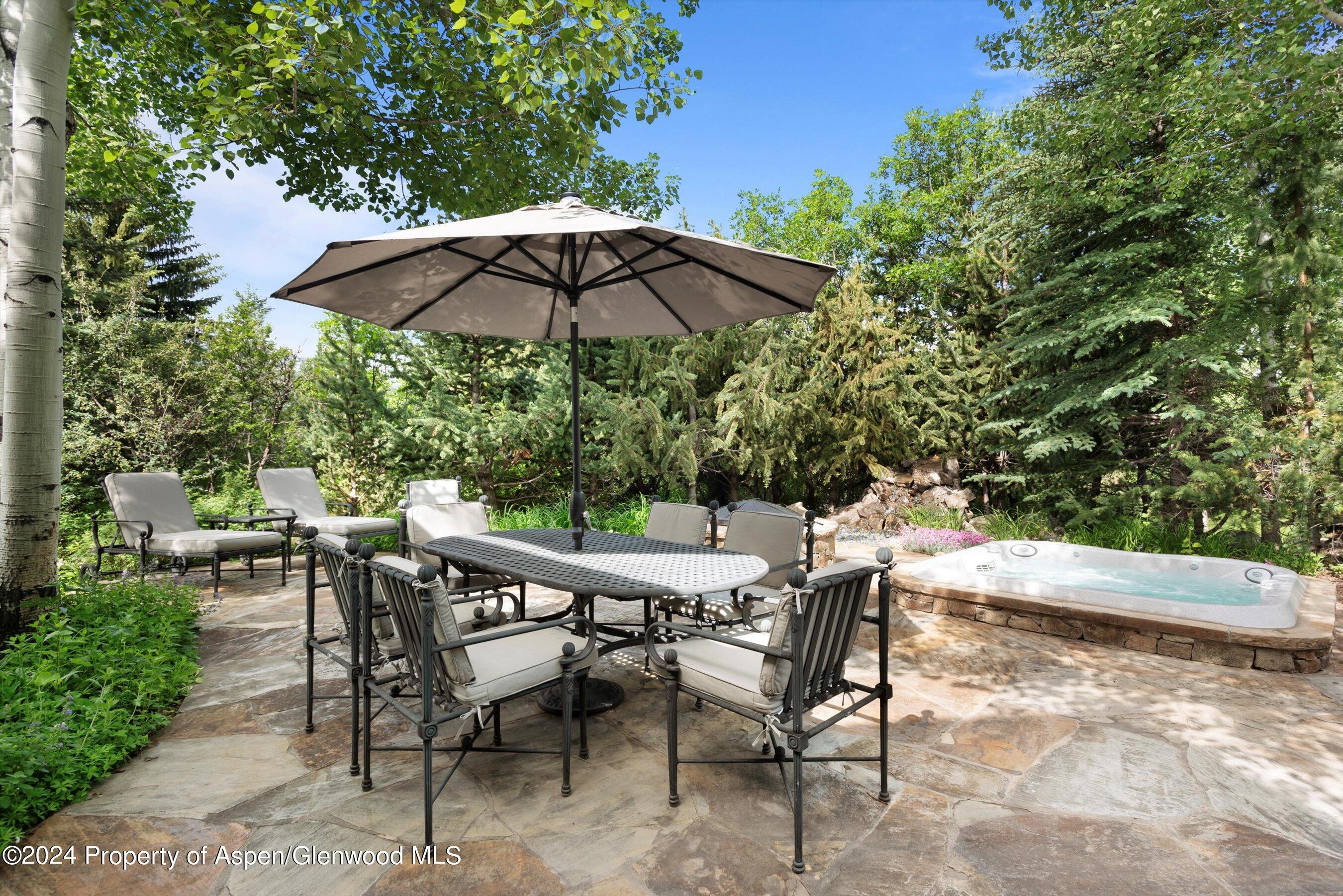 27 Nighthawk Drive Aspen, CO 81611 - Photo 43 of 61 a patio with a patio table and chairs