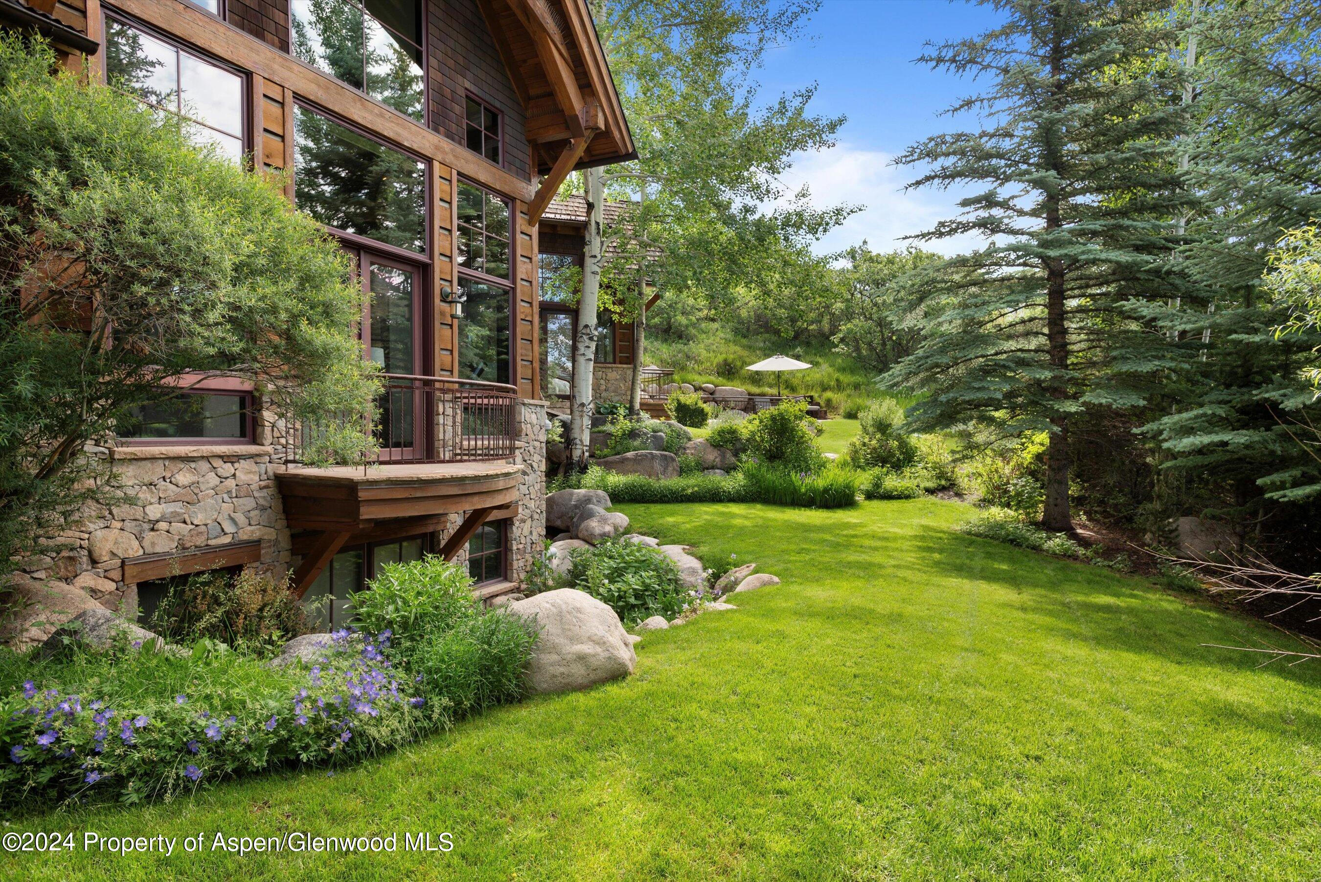 27 Nighthawk Drive Aspen, CO 81611 - Photo 46 of 61 a backyard of a house with lots of green space