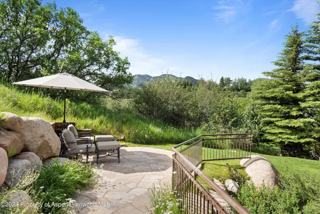 an aerial view of residential houses with outdoor space and trees