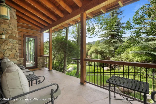 a view of a two chairs in the balcony