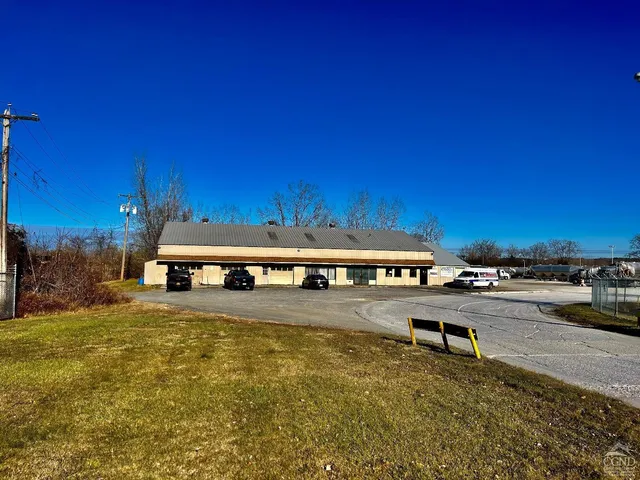 a view of a building with swimming pool and sitting area