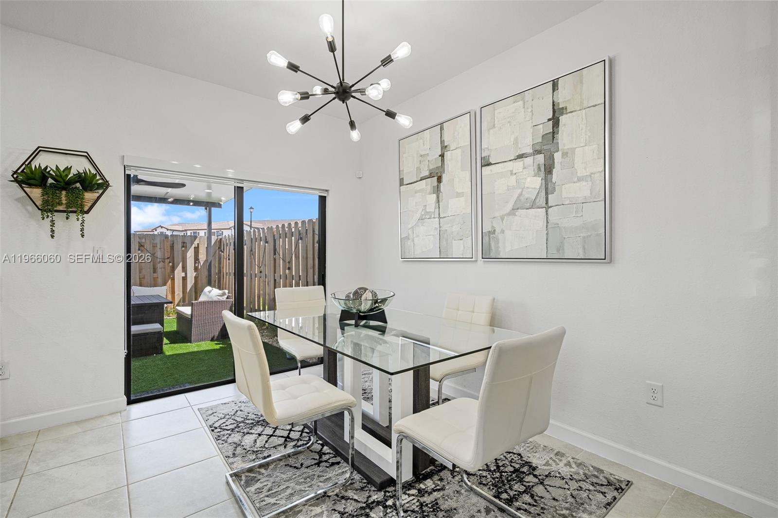 9941 Southwest 231st Lane, Unit 9941 Miami, FL 33190 - Photo 13 of 29 a dining room with furniture and window