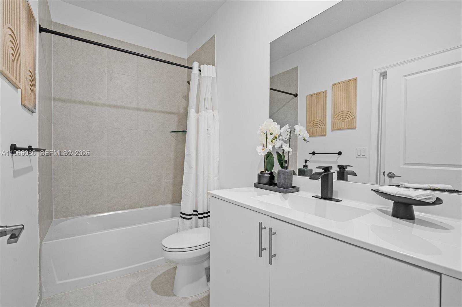 9941 Southwest 231st Lane, Unit 9941 Miami, FL 33190 - Photo 15 of 29 a bathroom with a sink a toilet and shower