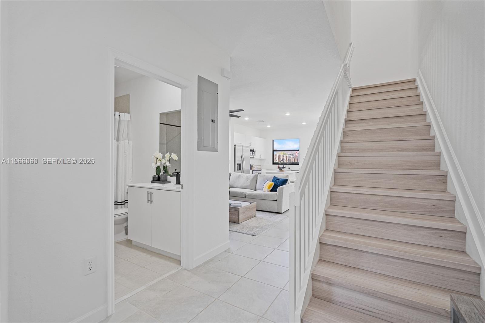 9941 Southwest 231st Lane, Unit 9941 Miami, FL 33190 - Photo 16 of 29 a hallway with white cabinets and white appliances
