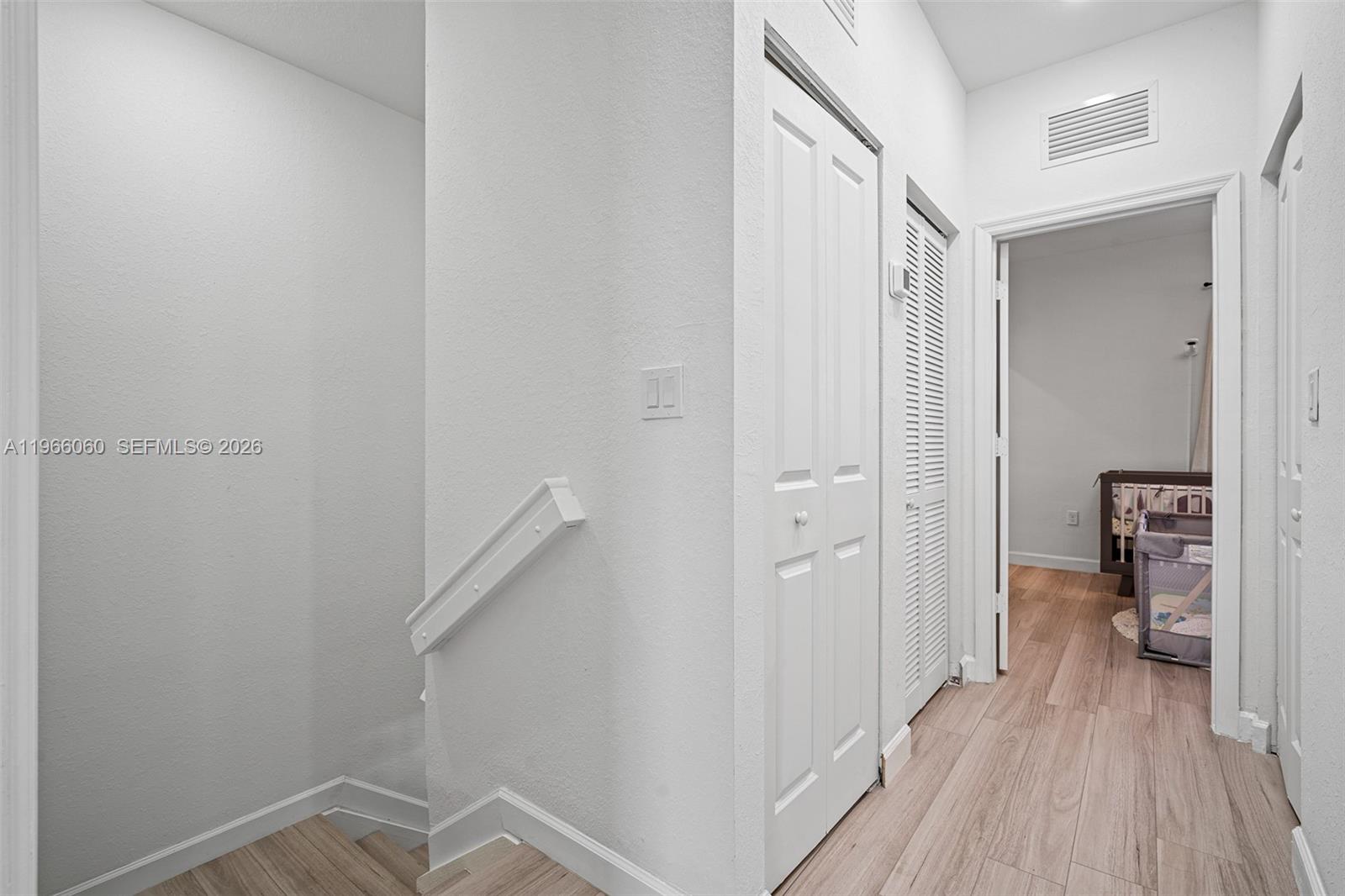 9941 Southwest 231st Lane, Unit 9941 Miami, FL 33190 - Photo 17 of 29 a view of a hallway with a livingroom and a bathroom