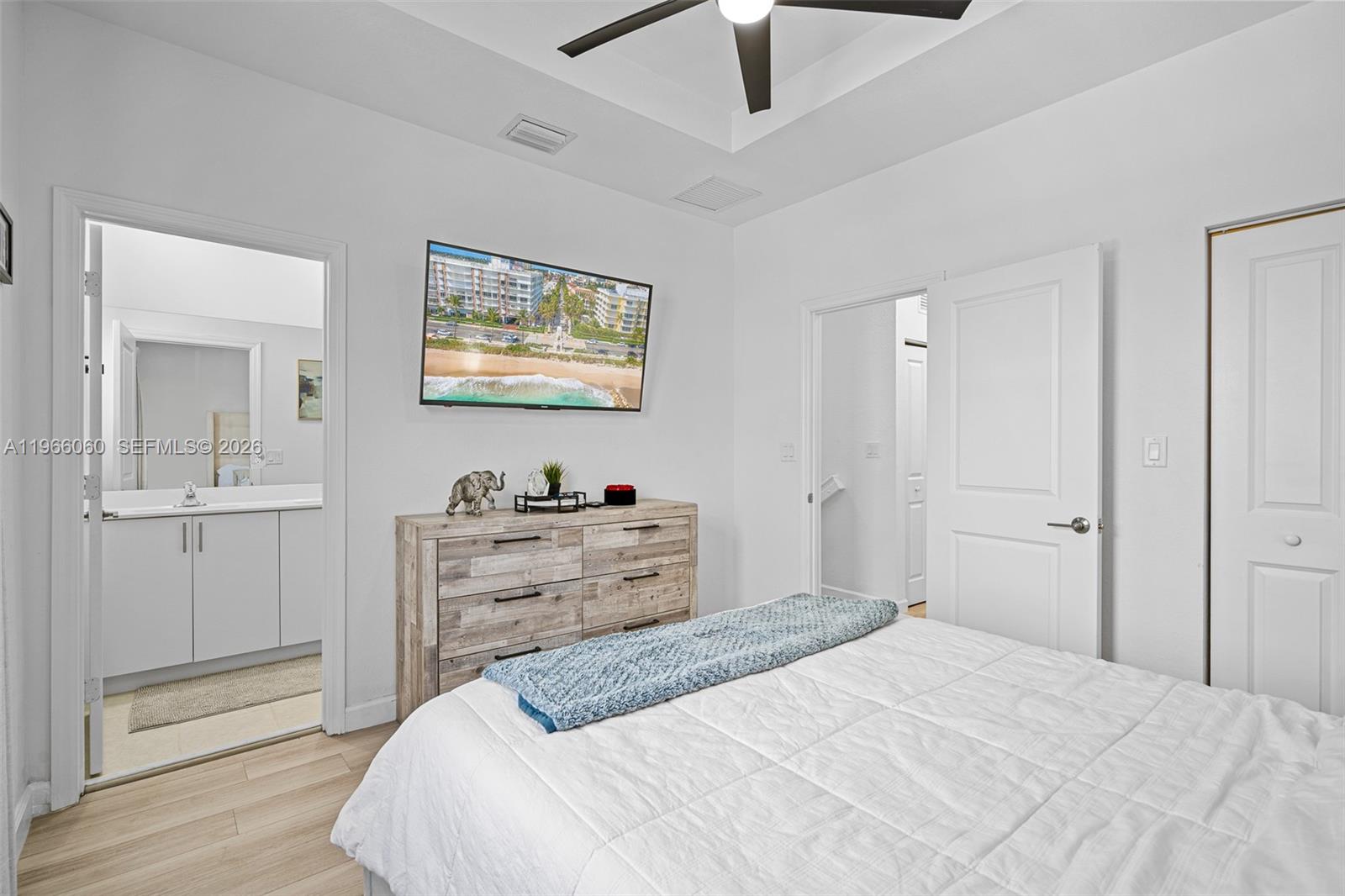 9941 Southwest 231st Lane, Unit 9941 Miami, FL 33190 - Photo 20 of 29 a bedroom with a bed and a view of bathroom