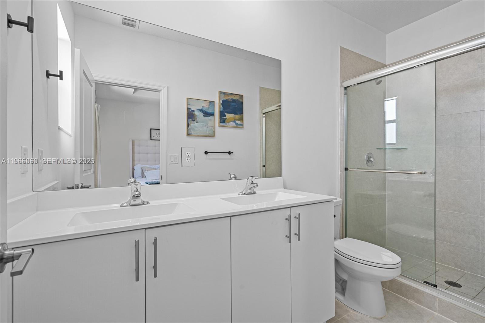 9941 Southwest 231st Lane, Unit 9941 Miami, FL 33190 - Photo 21 of 29 a bathroom with a sink toilet and shower