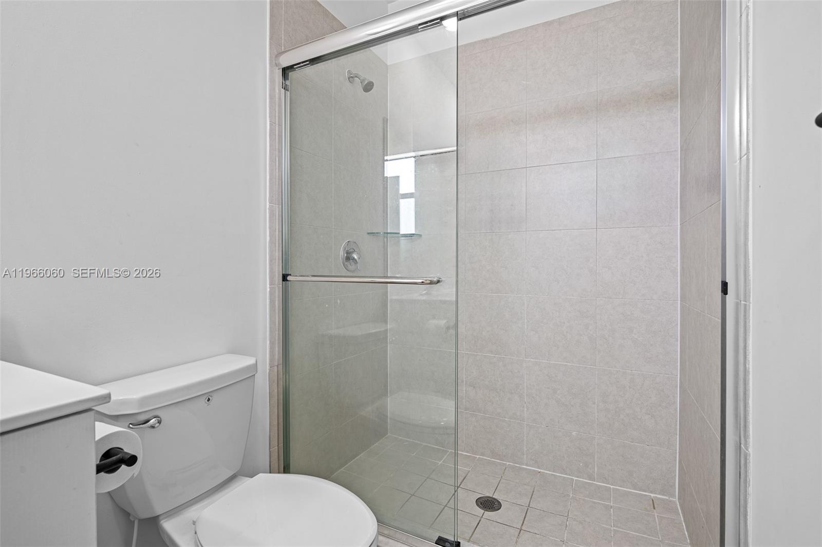 9941 Southwest 231st Lane, Unit 9941 Miami, FL 33190 - Photo 22 of 29 a bathroom with a shower and a toilet