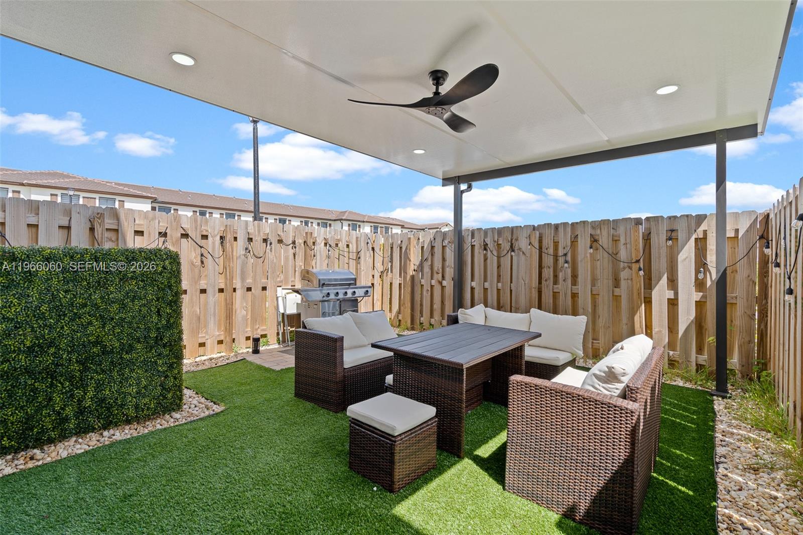 9941 Southwest 231st Lane, Unit 9941 Miami, FL 33190 - Photo 27 of 29 a outdoor space with patio couch and a garden