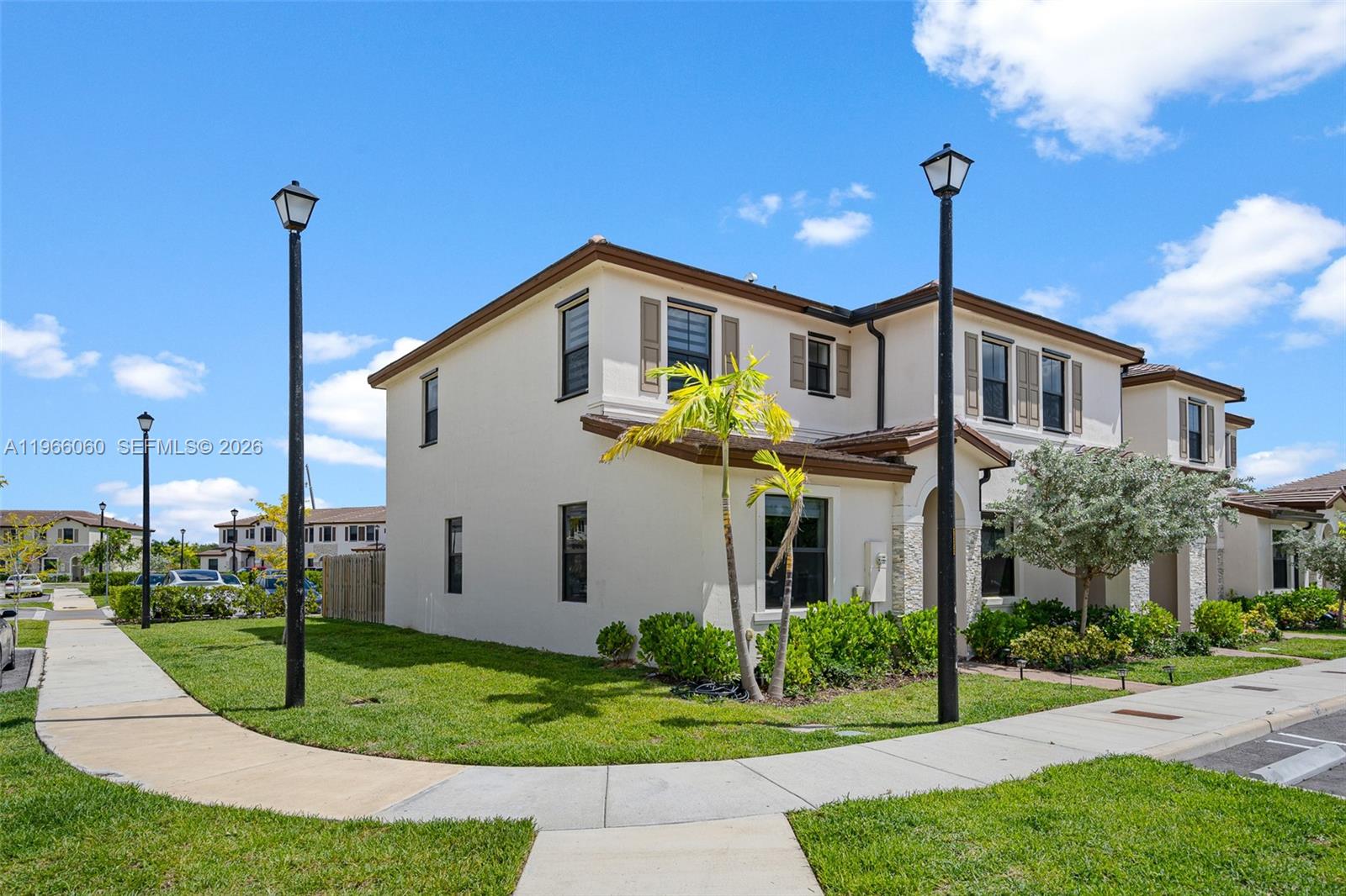 9941 Southwest 231st Lane, Unit 9941 Miami, FL 33190 - Photo 29 of 29 a front view of a house with a yard