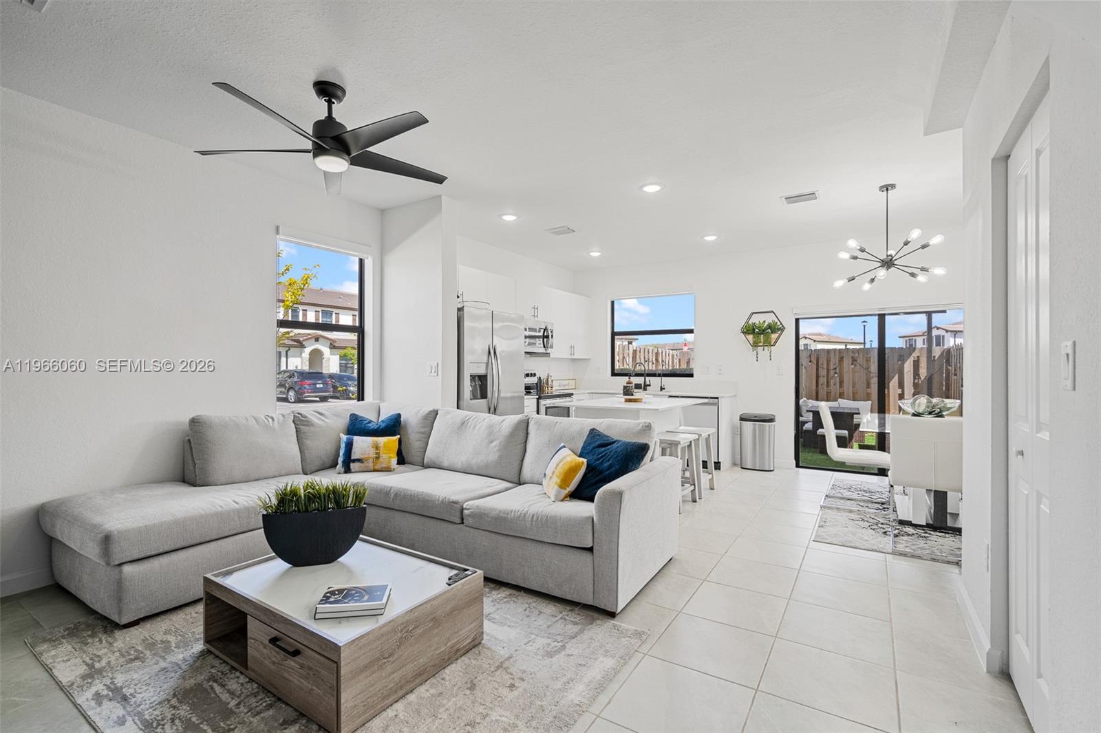 9941 Southwest 231st Lane, Unit 9941 Miami, FL 33190 - Photo 6 of 29 a living room with furniture and a view of kitchen
