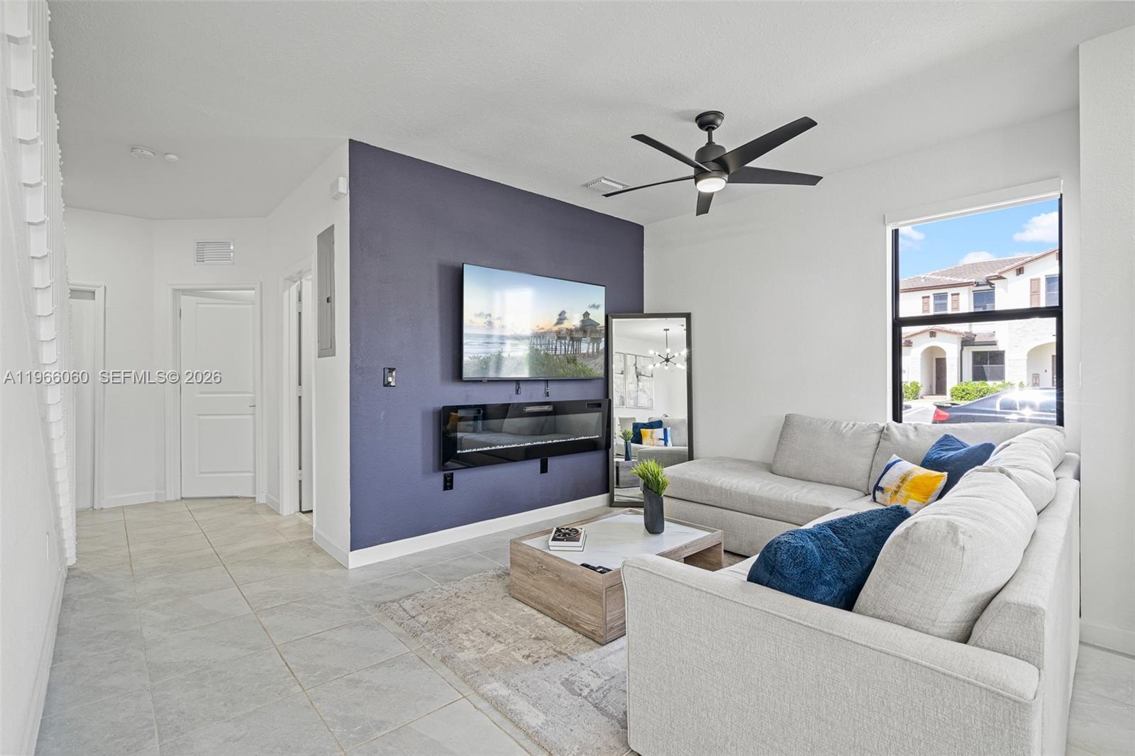 9941 Southwest 231st Lane, Unit 9941 Miami, FL 33190 - Photo 7 of 29 a living room with furniture and window