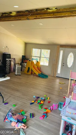 a room with wooden floor and furniture