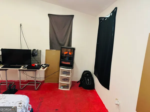 a bedroom with a bed and a desk
