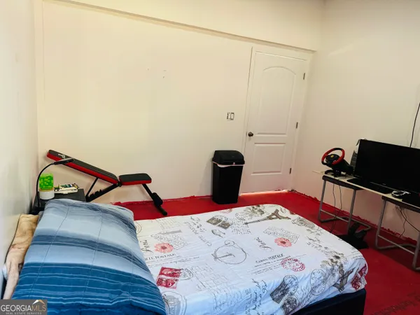 a bedroom with a bed and dresser