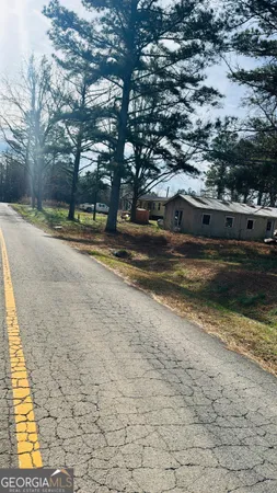 a view of a yard with large trees