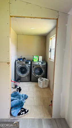 a bathroom with a sink vanity mirror and toilet