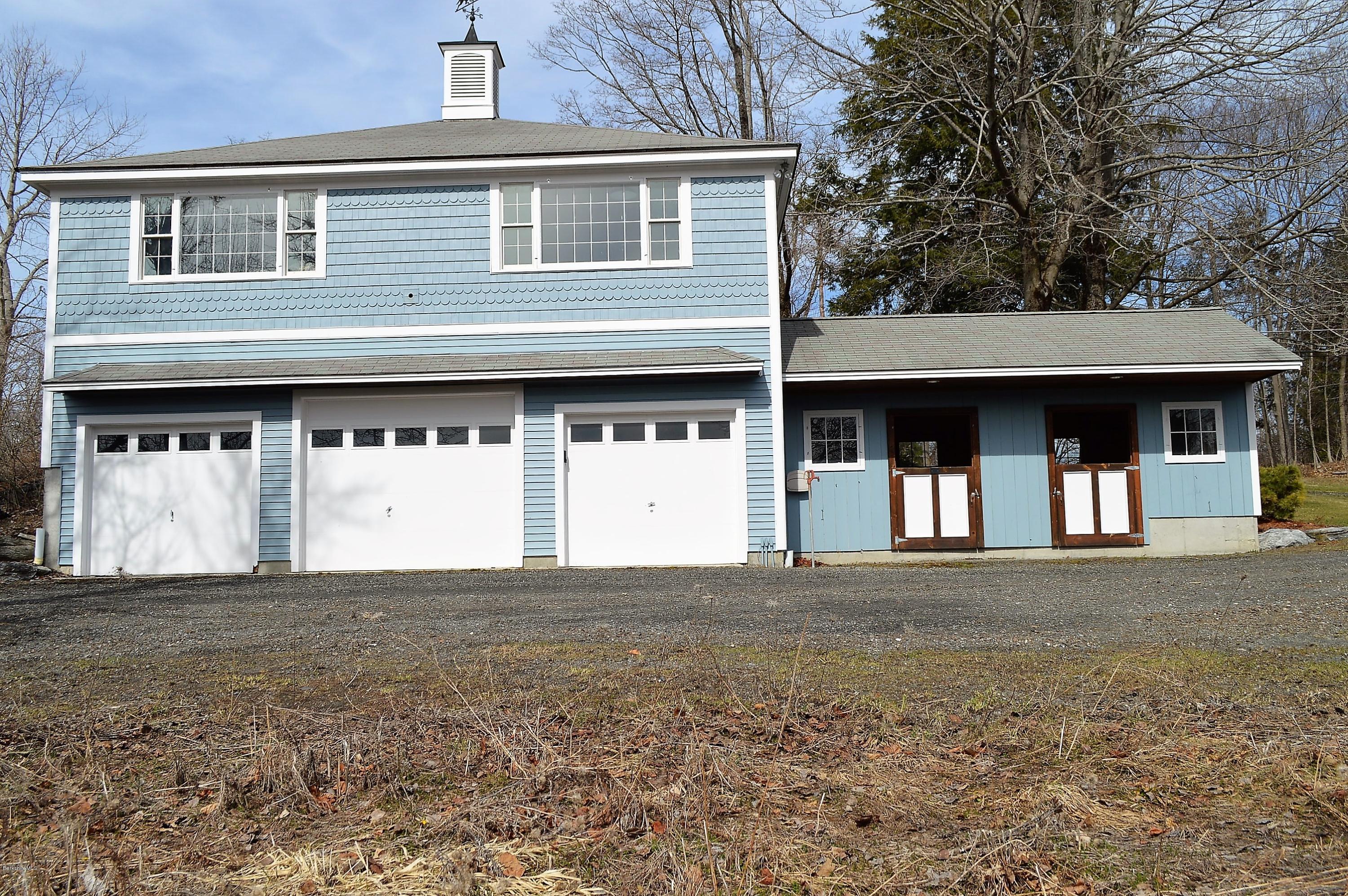 11 Rossiter Road Richmond, MA 01254 - Photo 3 of 40 a front view of a house with a garden and garage