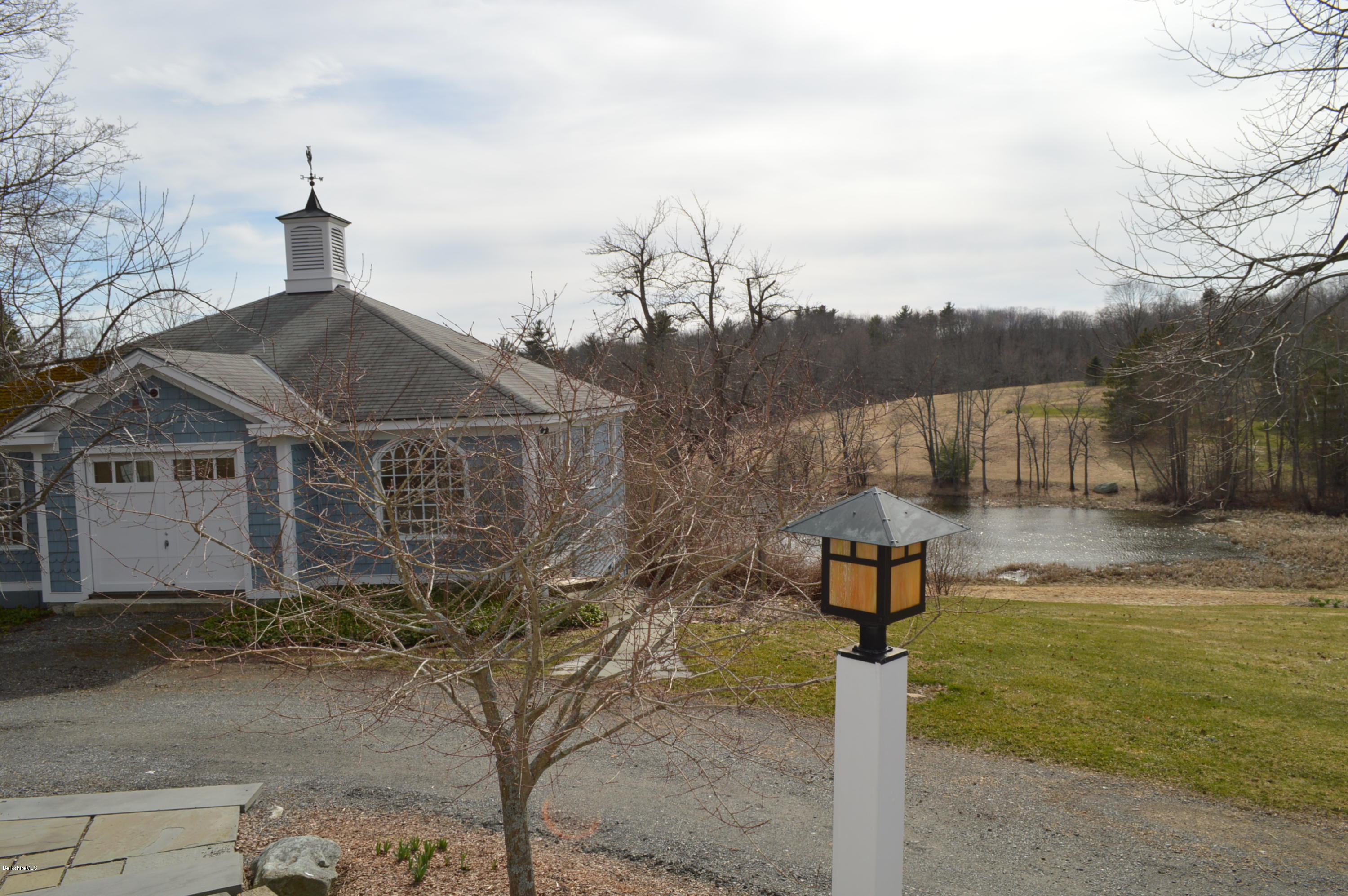 11 Rossiter Road Richmond, MA 01254 - Photo 33 of 40 a front view of a house with a yard and fountain in middle
