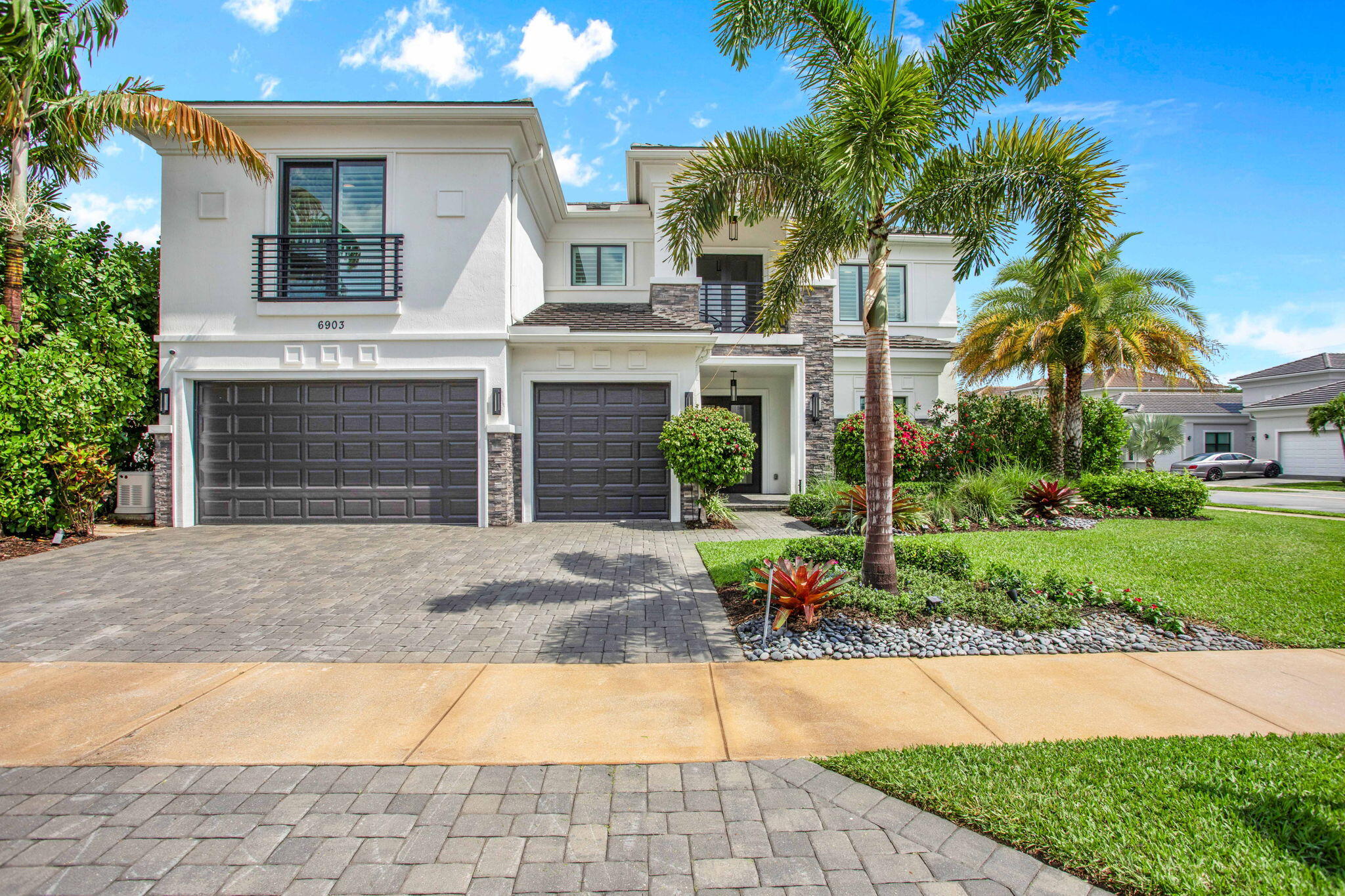 a front view of a house with a yard and a garage